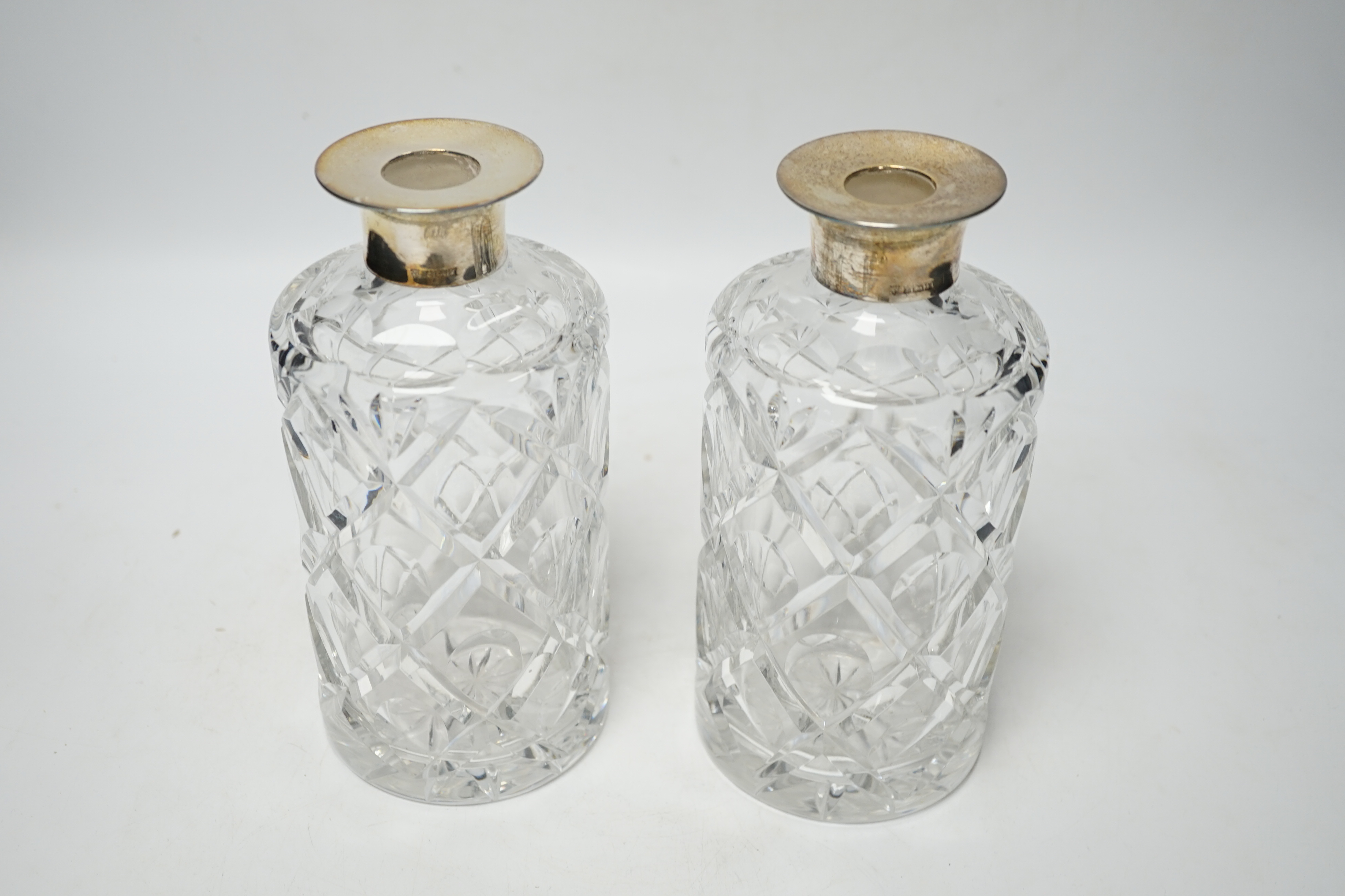 A modern pair of silver mounted cut glass cylindrical decanters with stoppers, Birmingham, 1971/73, 26cm.